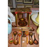 A collection of painted wooden items including stool,bowls and spoons.