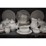 A part tea and dinner service by Harmony in a white and gilt design