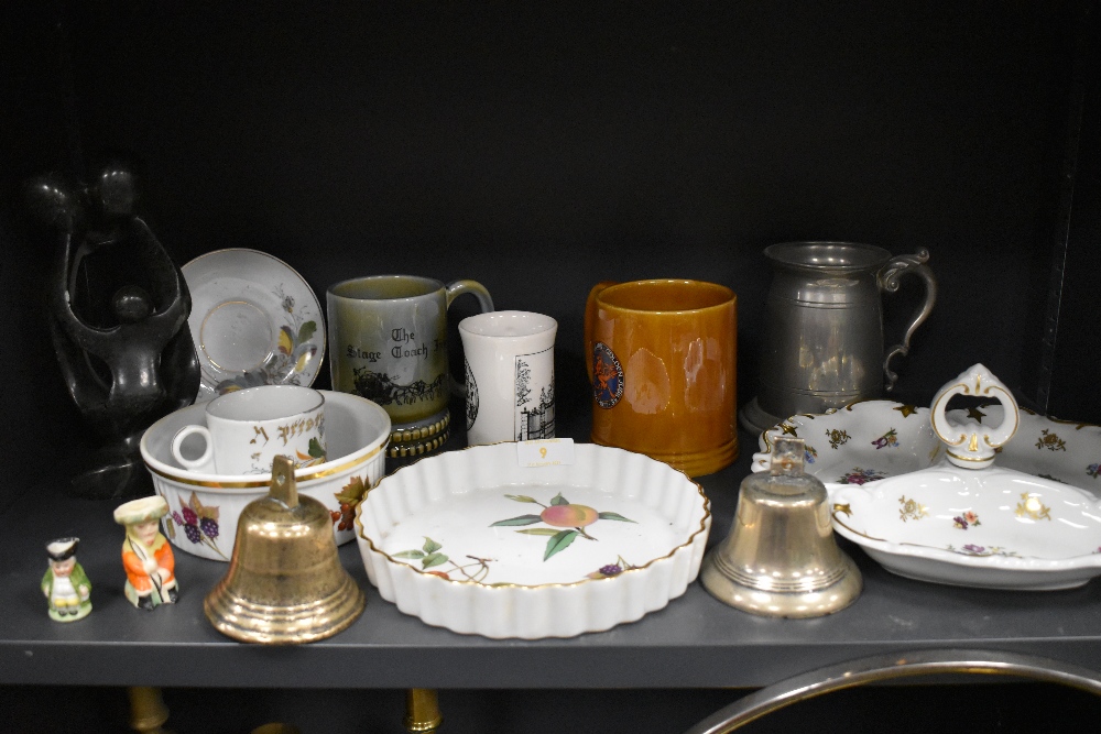 A selection of ceramics including Royal Worcester Evesham and two cast bells