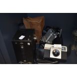A vintage box camera, a Kodak instamatic 25 and a Velbon tripod.