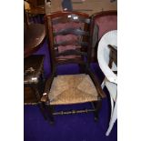 A rush seated low seat ladderback carver chair