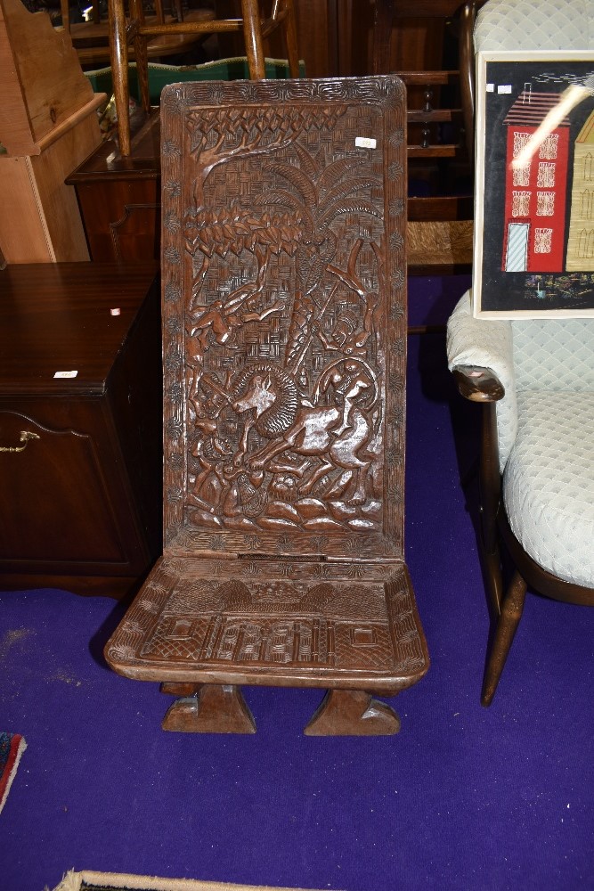 A tribal art carved ethnic palaver chair