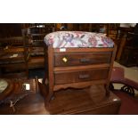 An early 20th Century stained frame piano stool, later upholstery to top, double drawer base