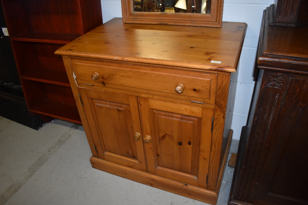 A pine cabinet, suitable for a variety of uses, with computer or entertainment style top drawer,