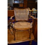 A traditional stained frame bergere armchair