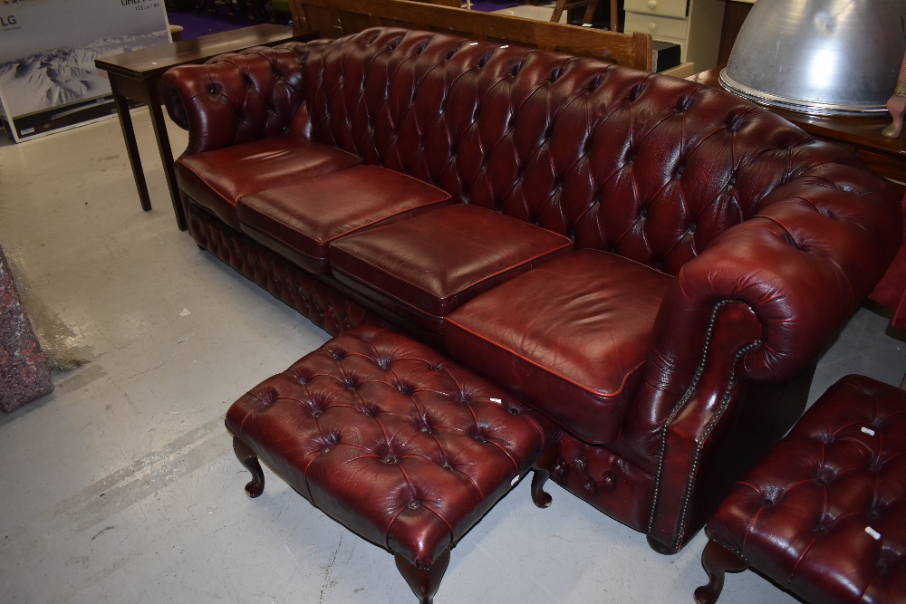 A reproduction burgundy leather four seater Chesterfield settee, width approx. 250cm and two similar