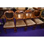 A set of four Victorian balloon back dining chairs