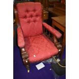 A 19th Century armchair having later red damask upholstery