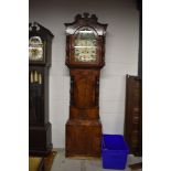A late 19th Century flame mahogany longcase clock having painted arch dial, 8 day movement,