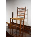 A traditional oak ladderback bedroom chair having strung seat