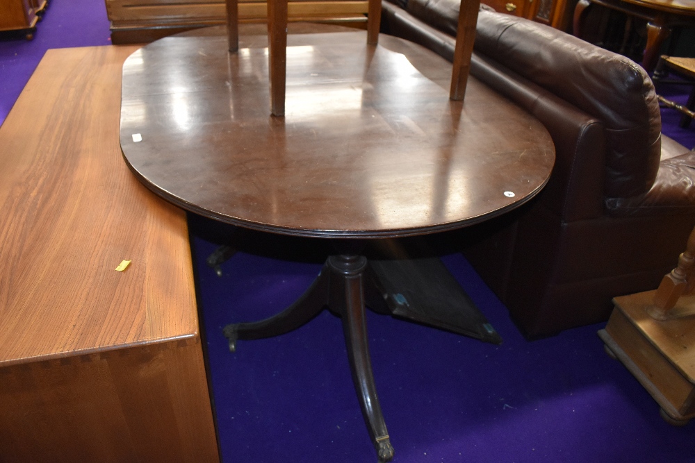 A Regency style extending dining table, nice quality on brass claw feet and casters, one