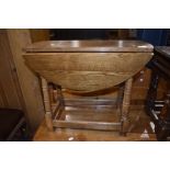 A light oak drop leaf occasional table , width approx. 64cm