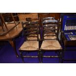 A traditional oak framed set of four rush seated ladderback chairs