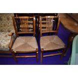 A pair of 19th Century rush seated rail back chairs