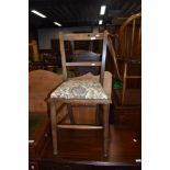 A traditional stained frame bedroom chair with upholstered seat