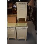 A pair of cream bedside cabinets