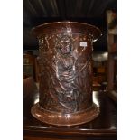 A copper coal bucket with embossed Geisha style decoration