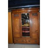 A Victorian mahogany double wardrobe having ash drawers dentil cornice over mirrored centre panel