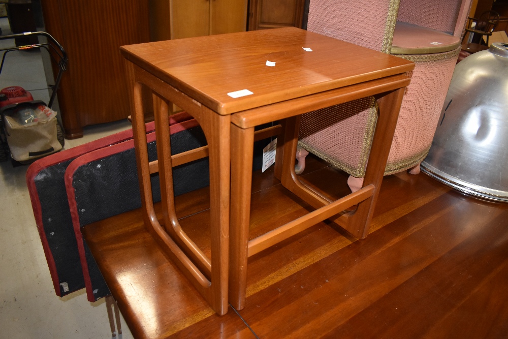 A vintage teak nest (two tables only), labelled McIntosh