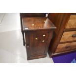 A traditional dark oak bedside pot cupboard, height approx. 75cm