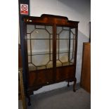 A 1920s mahogany display cabinet, on cabriole legs having ball and claw feet, approx. width 122cm,