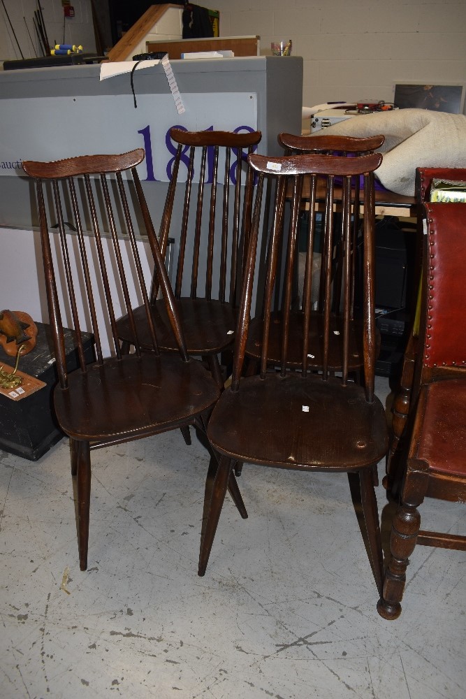 A set of four dark stained Ercol or similar high stick back kitchen/dining chairs