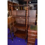 A Victorian mahogany whatnot etage, having four shaped tiers and drawer to base