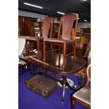 A modern mahogany effect reproduction Regency style dining table and four chairs having