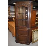 A mid to late 20th Century oak corner display cabinet with enclosed cupboard base, height approx.