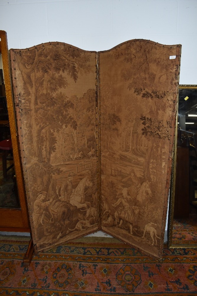 A vintage two panel room divider, having damask style hunting and foliate decoration and leather