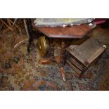 A Victorian stained frame octagonal occasional table on turned column frame and triple legs