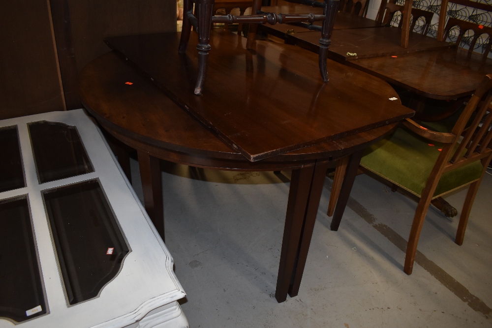 A georgian mahogany D end dining table having single centreleaf, on tapered legs, diameter 123cm,
