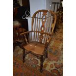 A traditional oak Windsor style high back kitchen chair