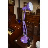 A modern lilac angle poise lamp