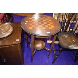 An early 20th mahogany occasional table having chequerboard top , diameter 52cm