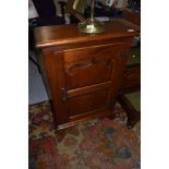 A reproduction oak shallow cupboard, dimensions approx. W57cm D24cm H84cm