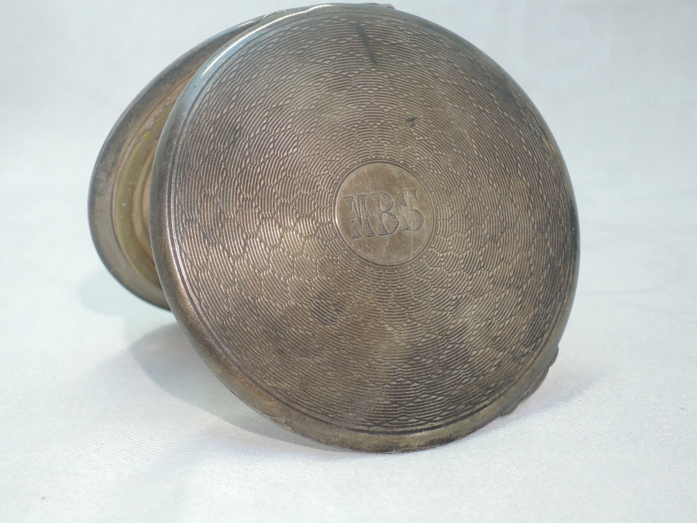 A silver powder compact having engine turned decoration and monogram to cartouche, Birmingham