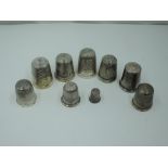 Nine HM silver and white metal thimbles of traditional forms including a miniature version, approx