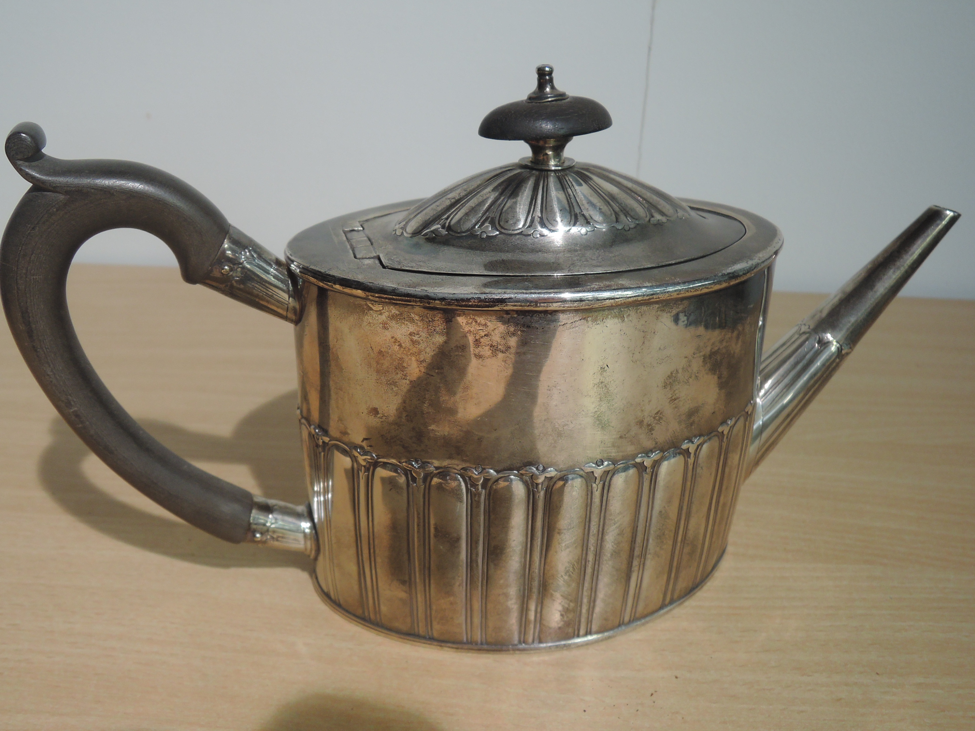 A Georgian silver teapot of drum form having gadrooned decoration and fruitwood handle, bearing - Image 7 of 7