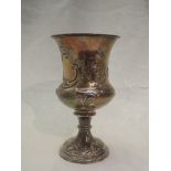 A Georgian silver chalice having flared rim, floral scroll repousse decoration on a reeded column