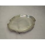 A small card tray of plain canted oval form having quatrefoil bracket feet and raised rim,London