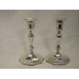 A pair of Edwardian silver candle sticks having removable sconces, shaped columns to stepped