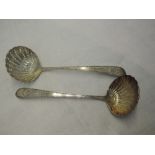 A pair of Irish Georgian silver sauce ladles having bright cut decoration to stems with