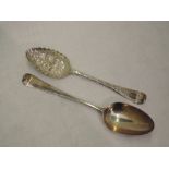 A Georgian silver berry spoon having frilled rim to bowl and later chased stem, London 1749,