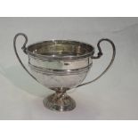 A small Edwardian silver trophy bowl of traditional form having loop handles and reeded