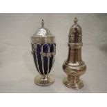 An Edwardian silver sugar caster having cage style body with blue glass liner and floral swag