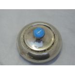A silver dressing table powder pot of plain circular form with blue enamel guilloche decoration to