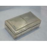 A silver cigarette box of rectangular form having engine turned wave decoration to lid with crest to
