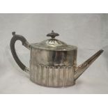 A Georgian silver teapot of drum form having gadrooned decoration and fruitwood handle, bearing