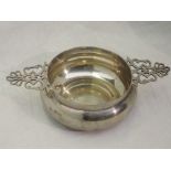 A Victorian silver porringer of plain circular form having decorative pierced handles and name